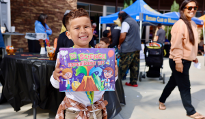 boy holding science kit at resource fair